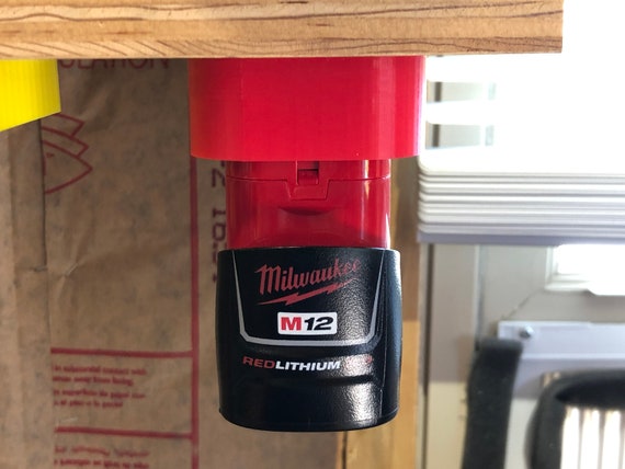 Milwaukee M12 battery holder mounted for storage